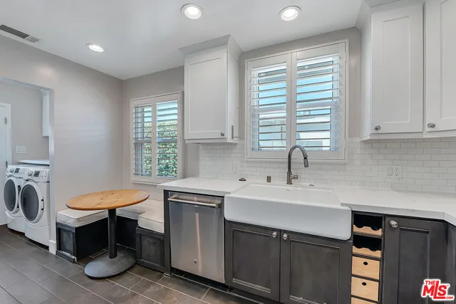 a kitchen with a sink cabinets and a window