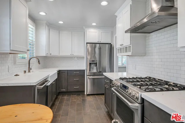 a kitchen with a stove a sink and a refrigerator