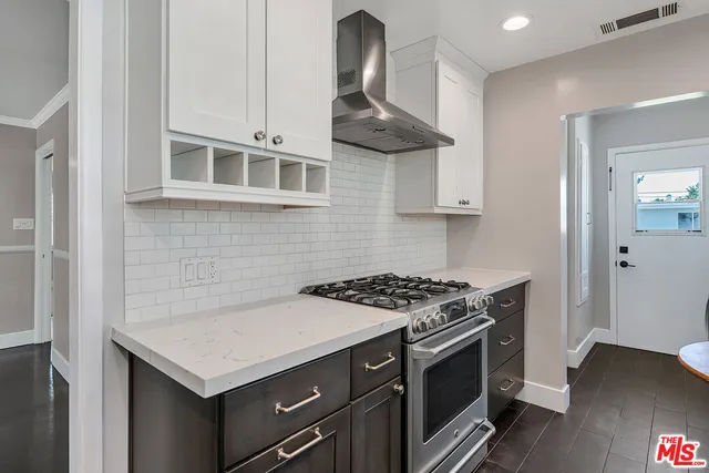 a kitchen with stainless steel appliances a stove and a microwave