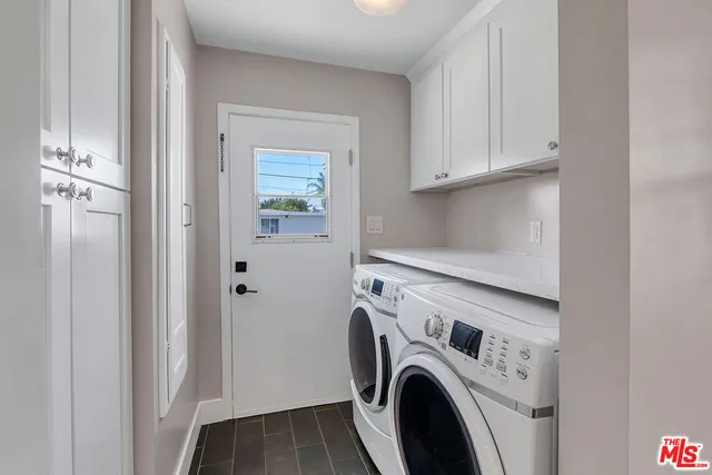 a view of storage and utility room with washer and dryer