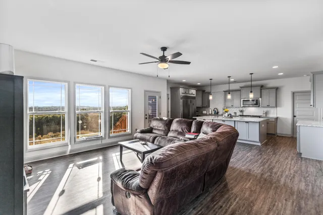 a bedroom with bed couch and window