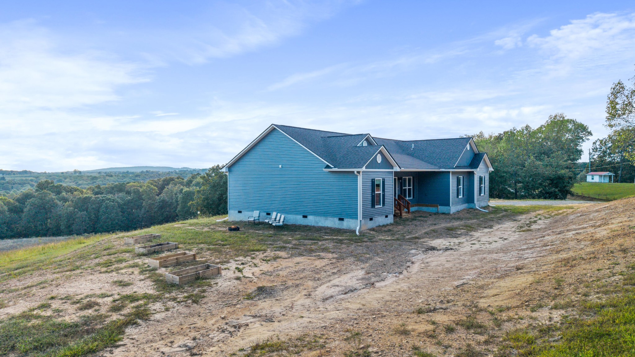 610 Summer City Firetower Road Pikeville, TN 37367 - Photo 5 of 60 a view of a house with a small yard and a large tree