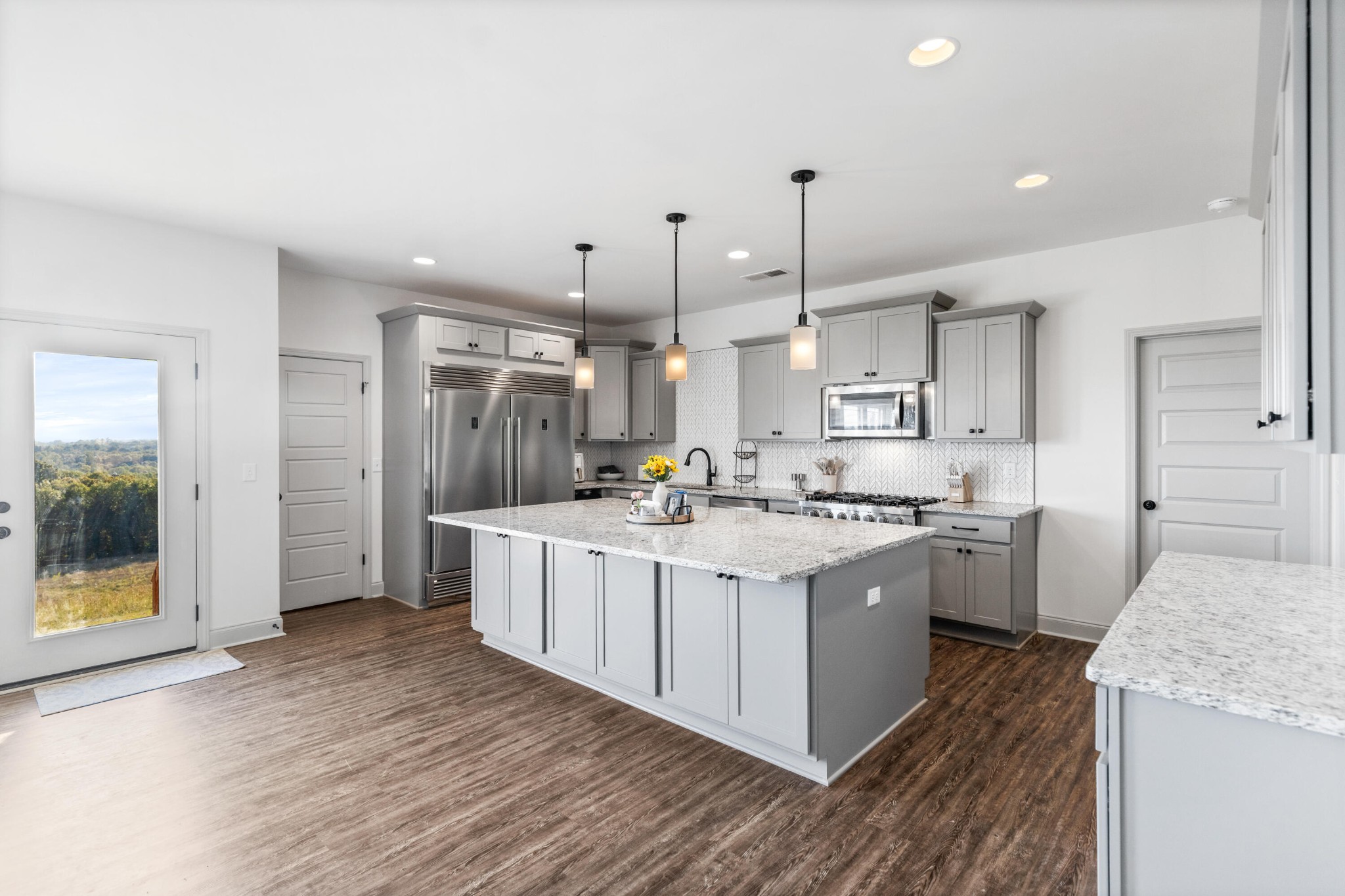610 Summer City Firetower Road Pikeville, TN 37367 - Photo 9 of 60 a large kitchen with stainless steel appliances kitchen island a large counter top and a wooden floors