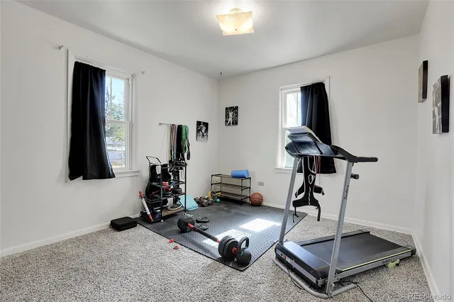 a room with gym equipment and a mirror