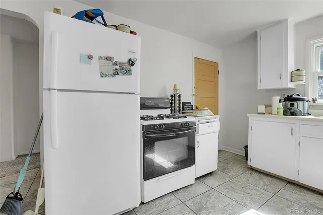 a white refrigerator freezer sitting inside of a kitchen