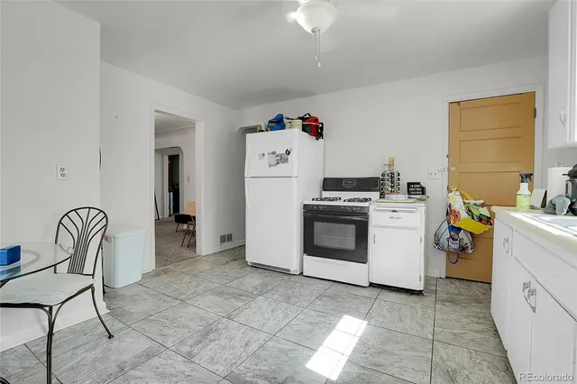 a utility room with dryer washer and a view of living room