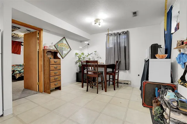 a view of a livingroom with furniture and gym equipment