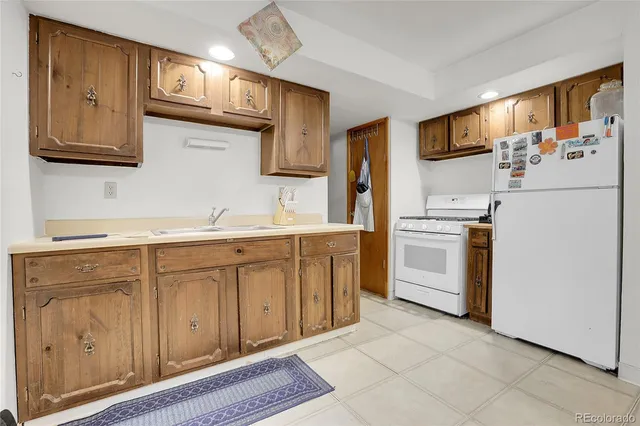 a kitchen with white cabinets and white appliances