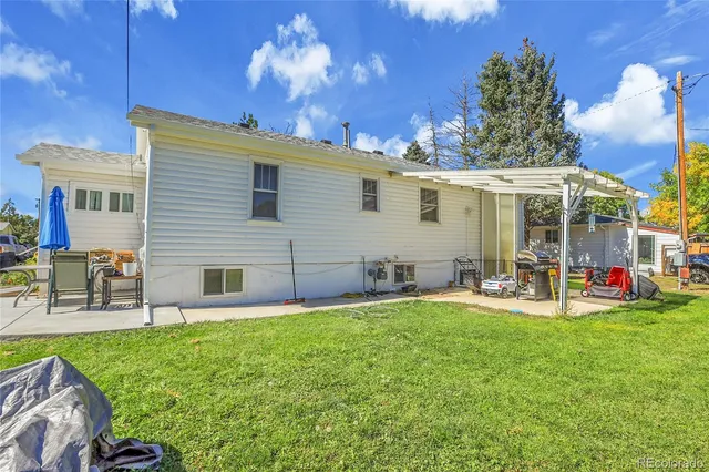 a view of a house with patio and a yard