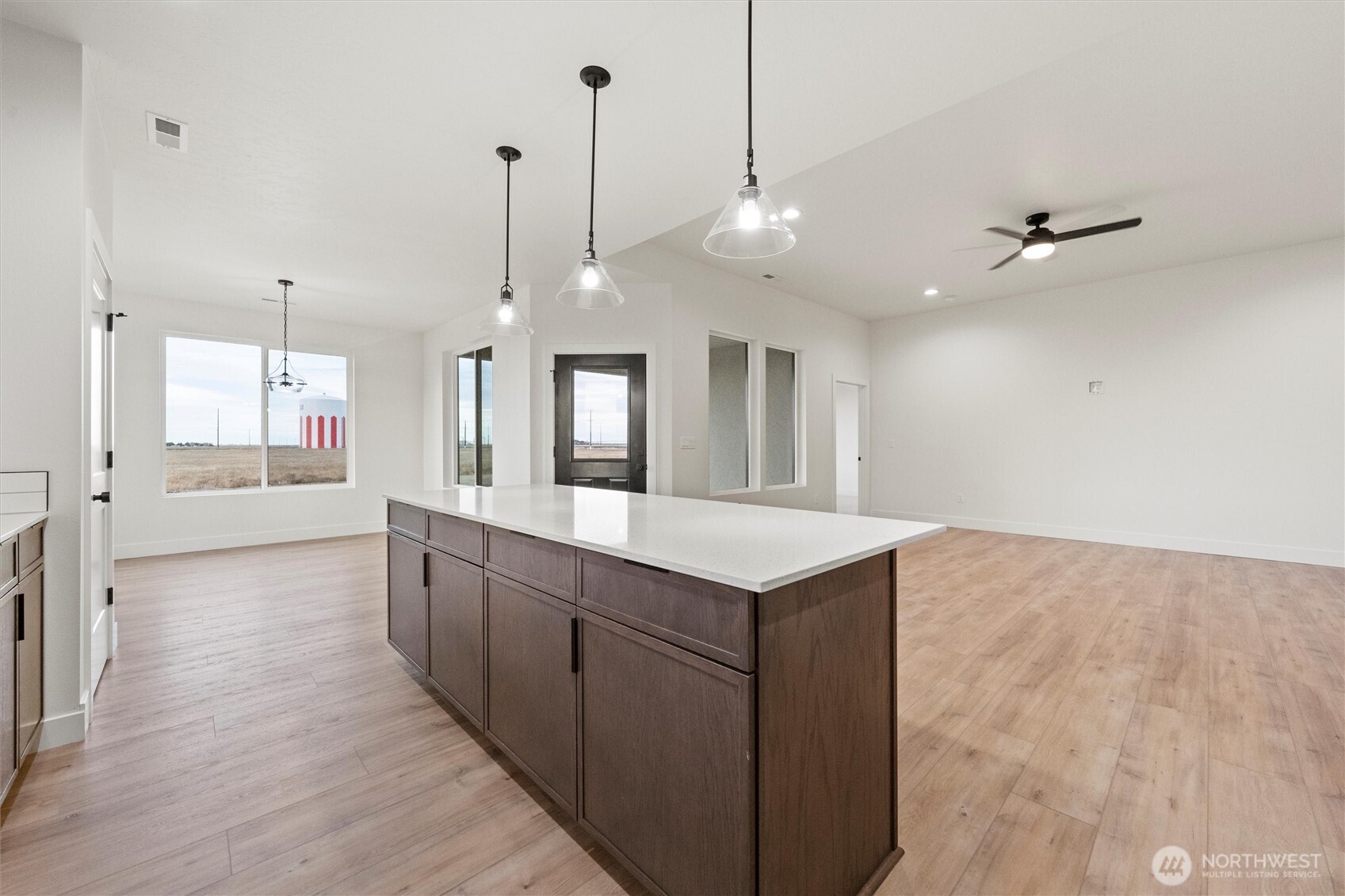 1269 E Mount Othello, WA 99344 - Photo 12 of 32 a large kitchen with cabinets a sink and wooden floor