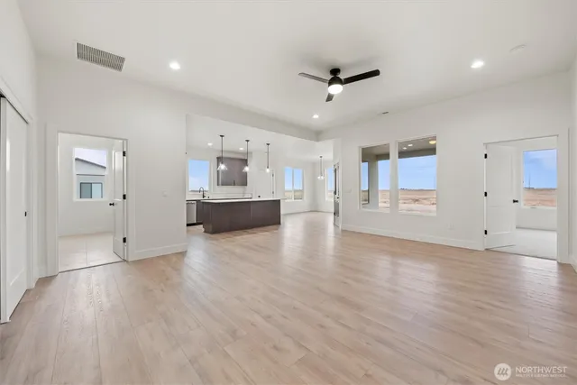 a view of empty room with wooden floor and window