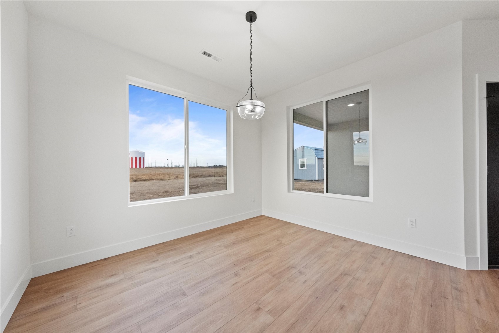 1269 E Mount Othello, WA 99344 - Photo 22 of 32 a view of a room with windows and wooden floor