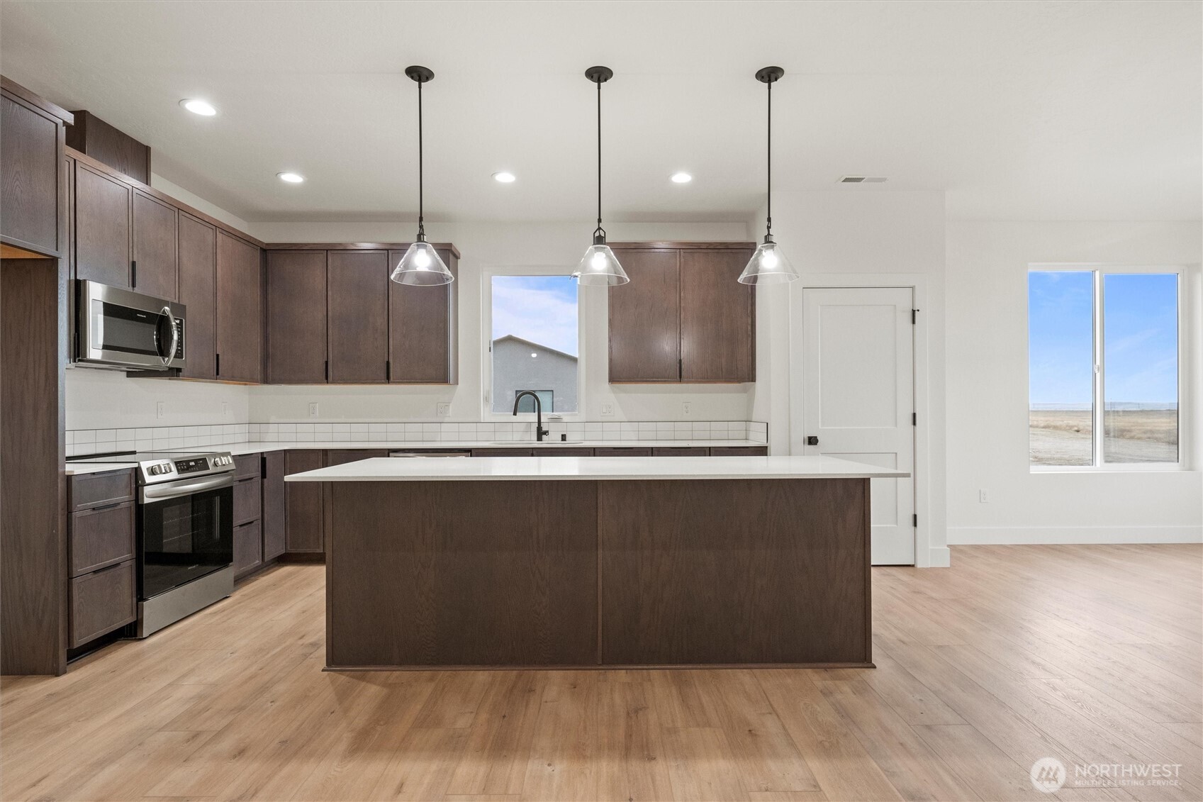 1269 E Mount Othello, WA 99344 - Photo 5 of 32 a kitchen with kitchen island a sink and a stove