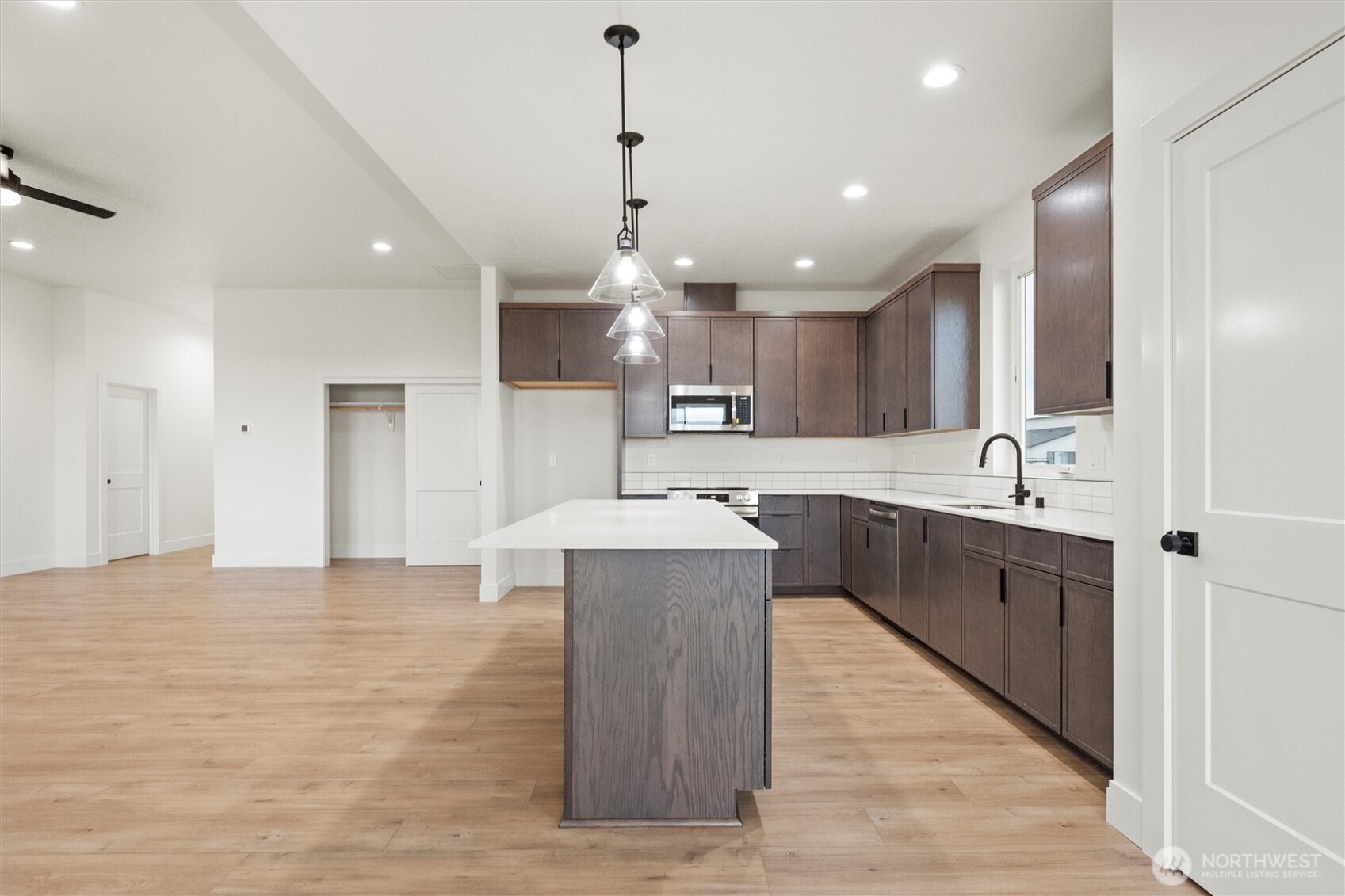 1269 E Mount Othello, WA 99344 - Photo 6 of 32 a large kitchen with kitchen island a sink stainless steel appliances and a center island