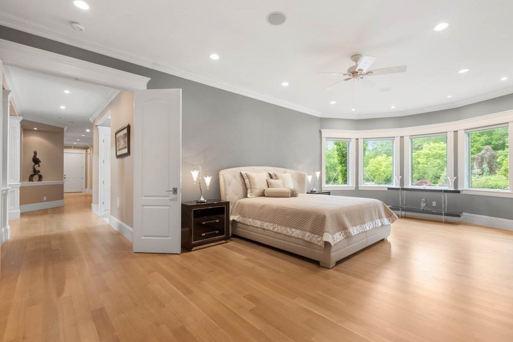 19 Ross Lane Middleton, MA 01949 - Photo 21 of 42 a spacious bedroom with a large bed and a large window