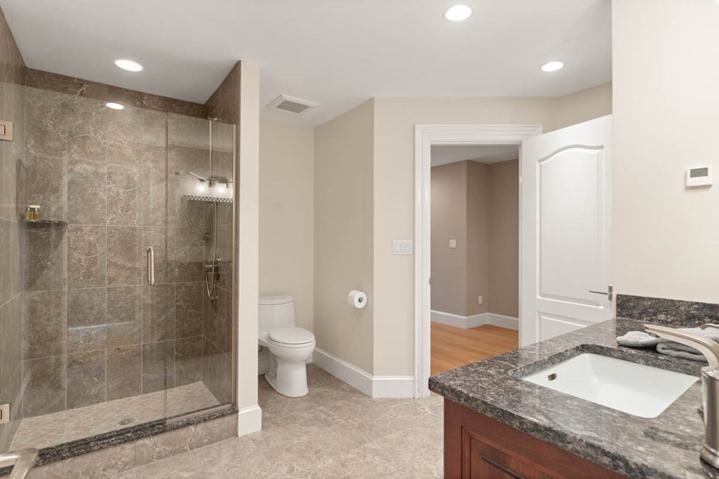 19 Ross Lane Middleton, MA 01949 - Photo 24 of 42 a bathroom with a granite countertop sink a toilet and shower