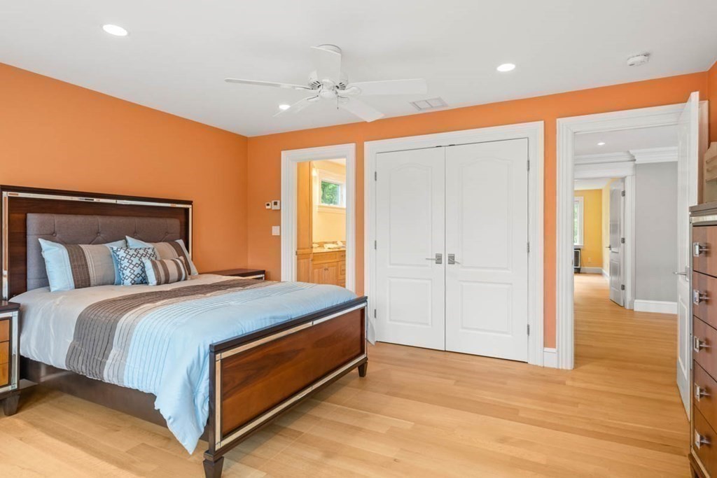 19 Ross Lane Middleton, MA 01949 - Photo 25 of 42 a bedroom with a bed and a chandelier