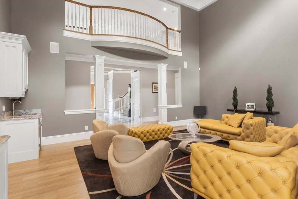 19 Ross Lane Middleton, MA 01949 - Photo 6 of 42 a living room with furniture a rug and a chandelier
