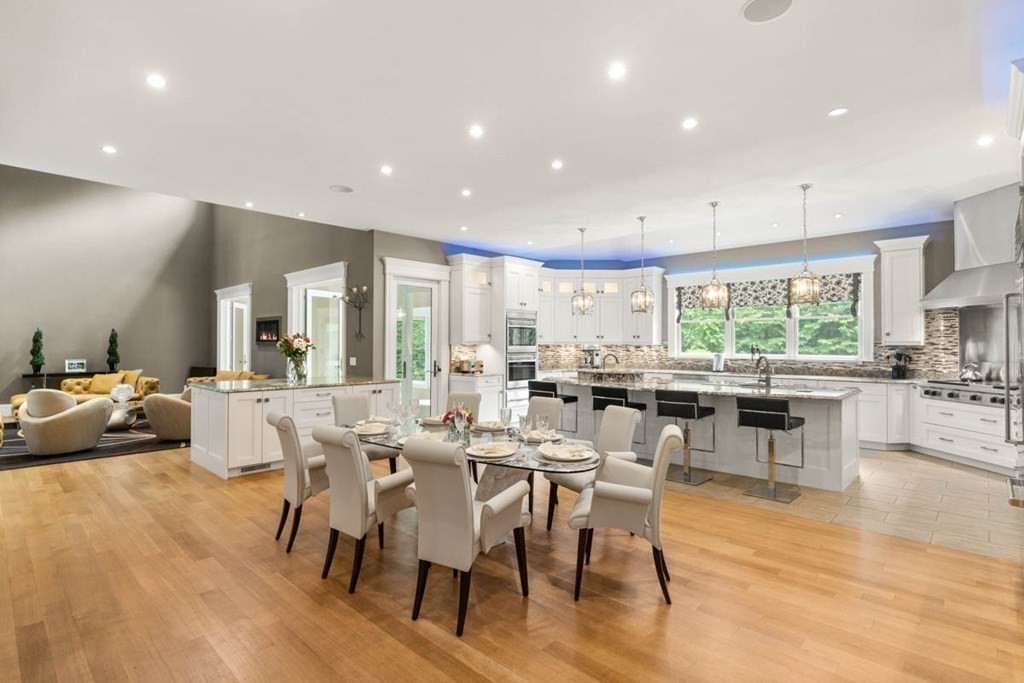 19 Ross Lane Middleton, MA 01949 - Photo 8 of 42 a large kitchen with lots of furniture a sink appliances and a dining table