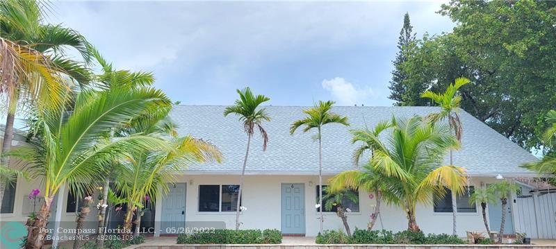 a view of a palm trees in front of a house