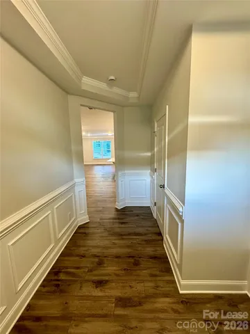 a view of an empty room and wooden floor
