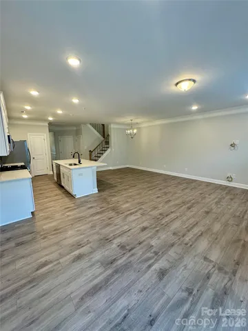 a kitchen with stainless steel appliances a sink stove and cabinets