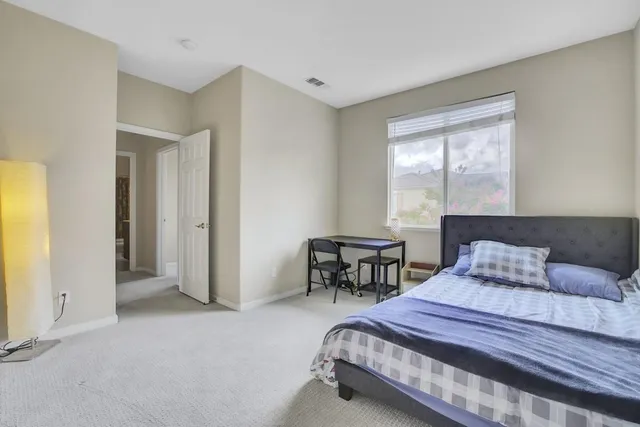 a bedroom with a bed and a table