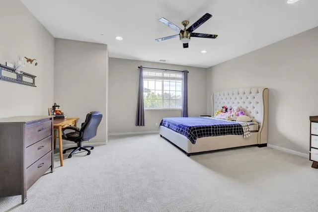 a bedroom with a bed and chair