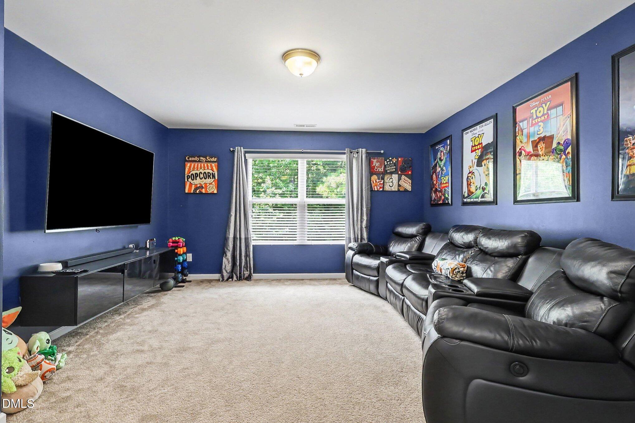 4366 Auburn Hills Drive Raleigh, NC 27616 - Photo 21 of 40 a living room with furniture and a flat screen tv