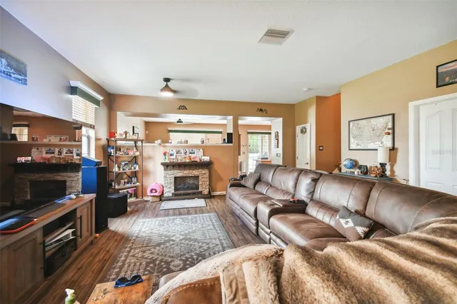 a living room with furniture fireplace and flat screen tv
