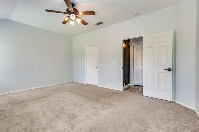 a view of a room with a ceiling fan and a chandelier fan