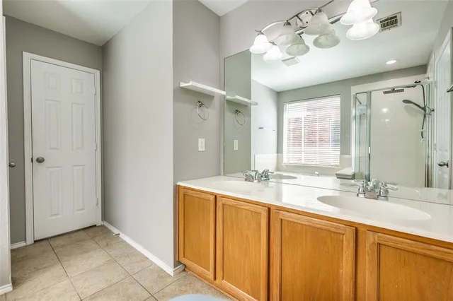 a bathroom with a sink double vanity and a mirror