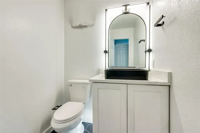 a bathroom with a toilet a sink and mirror