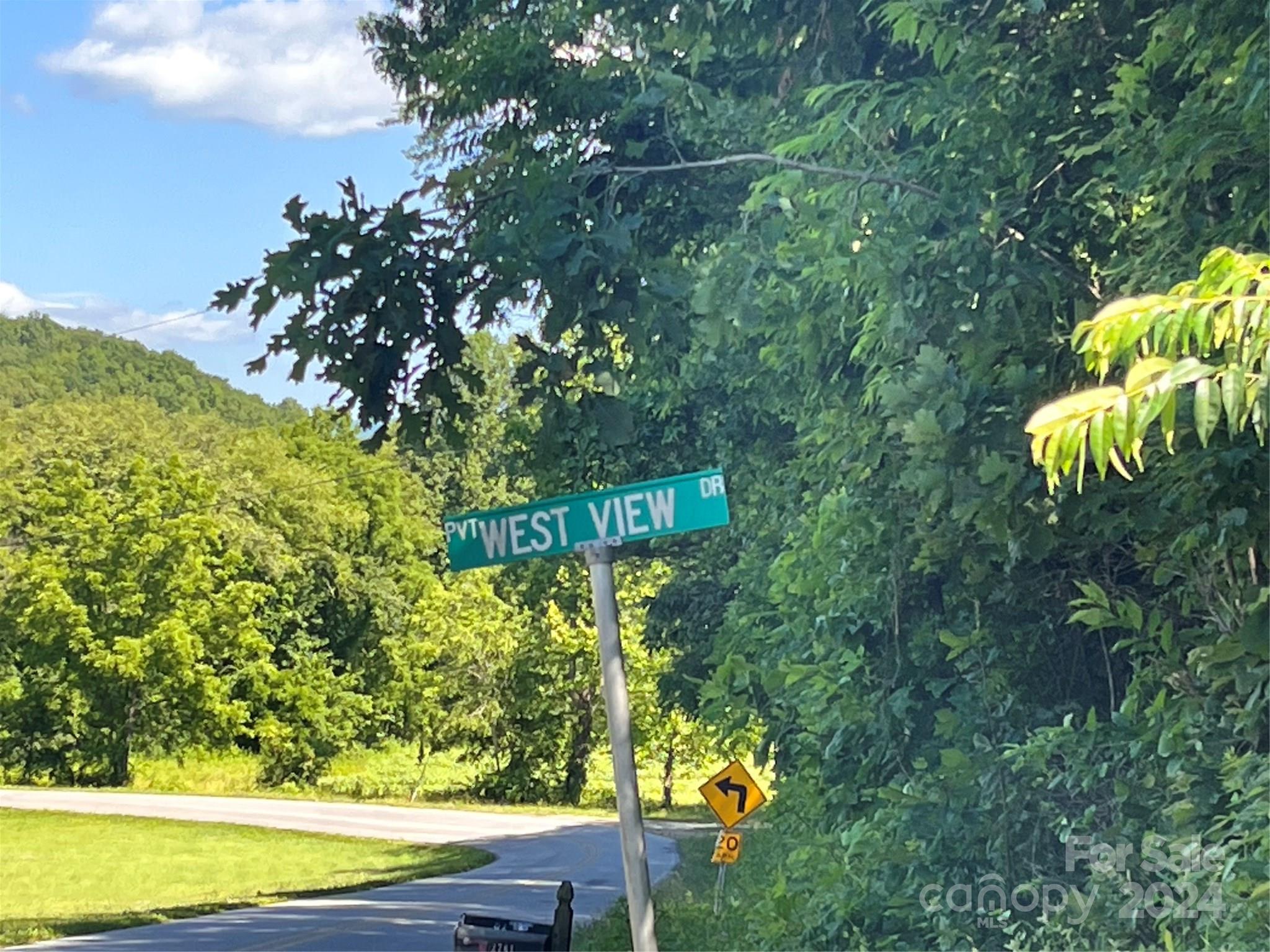 a street sign that is on a tree