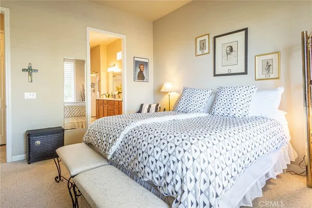 a bedroom with a bed and painting on the wall