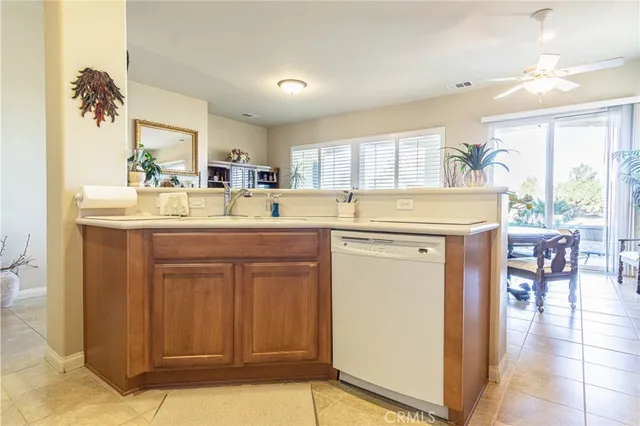 a kitchen with a sink a stove a refrigerator and cabinets