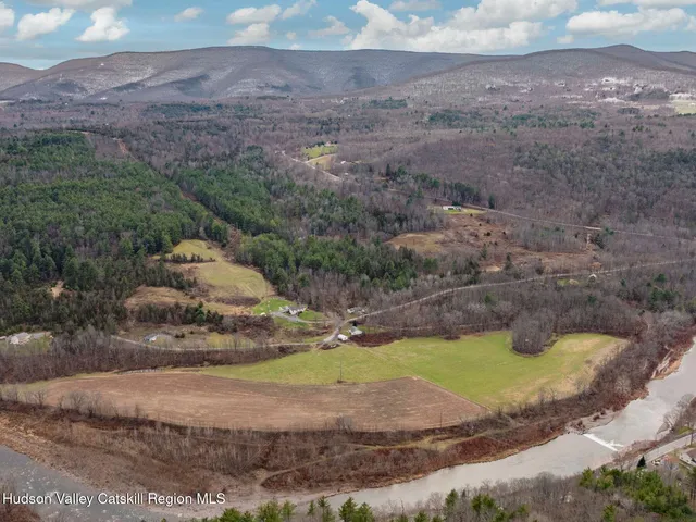a view of a lake with beach and mountain view