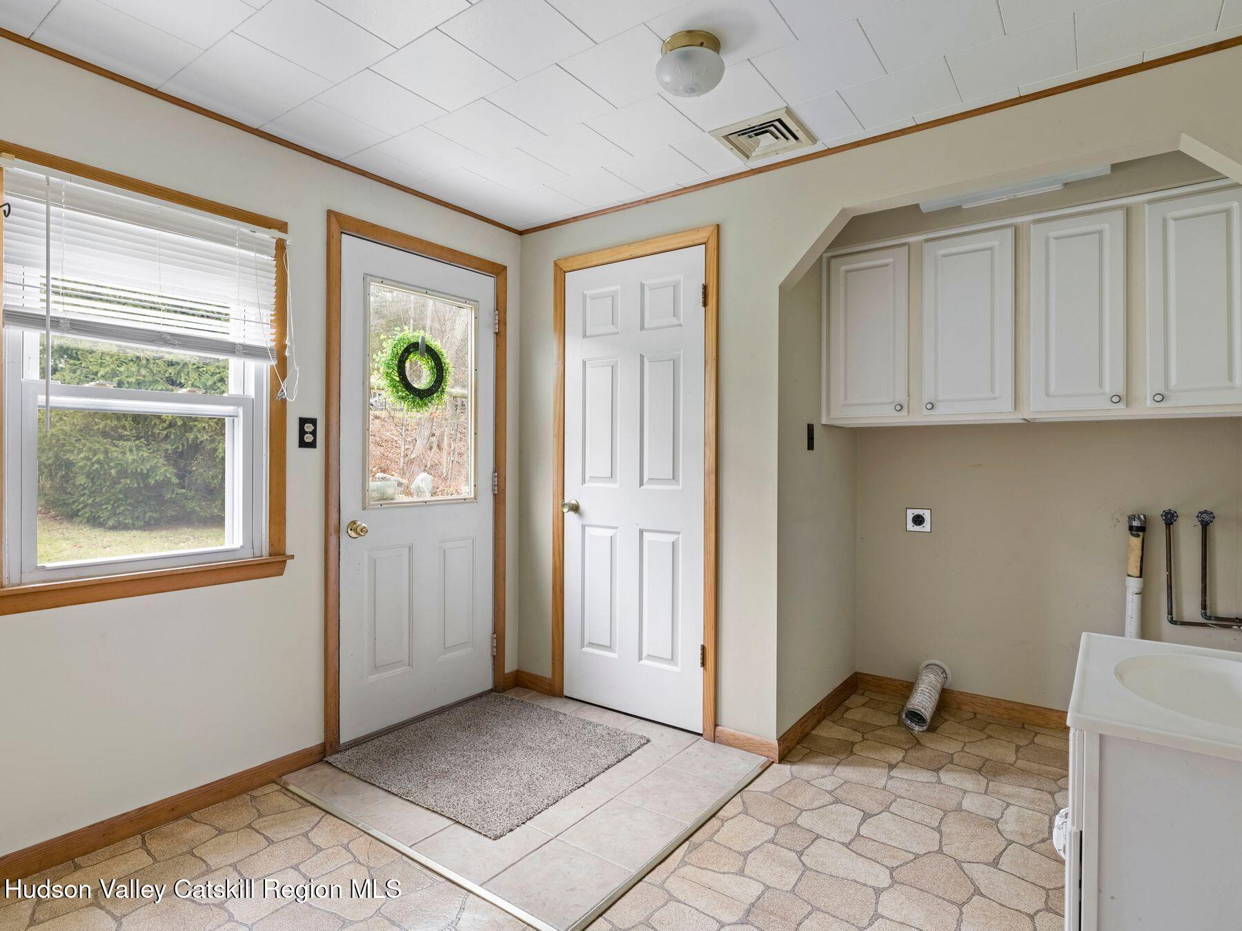 169 Mattice Road Prattsville, NY 12468 - Photo 22 of 52 a view of an empty room with window and cabinet