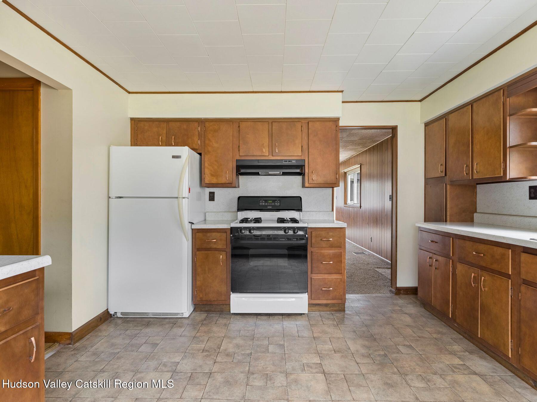 169 Mattice Road Prattsville, NY 12468 - Photo 25 of 52 a kitchen with stainless steel appliances granite countertop a refrigerator and a stove