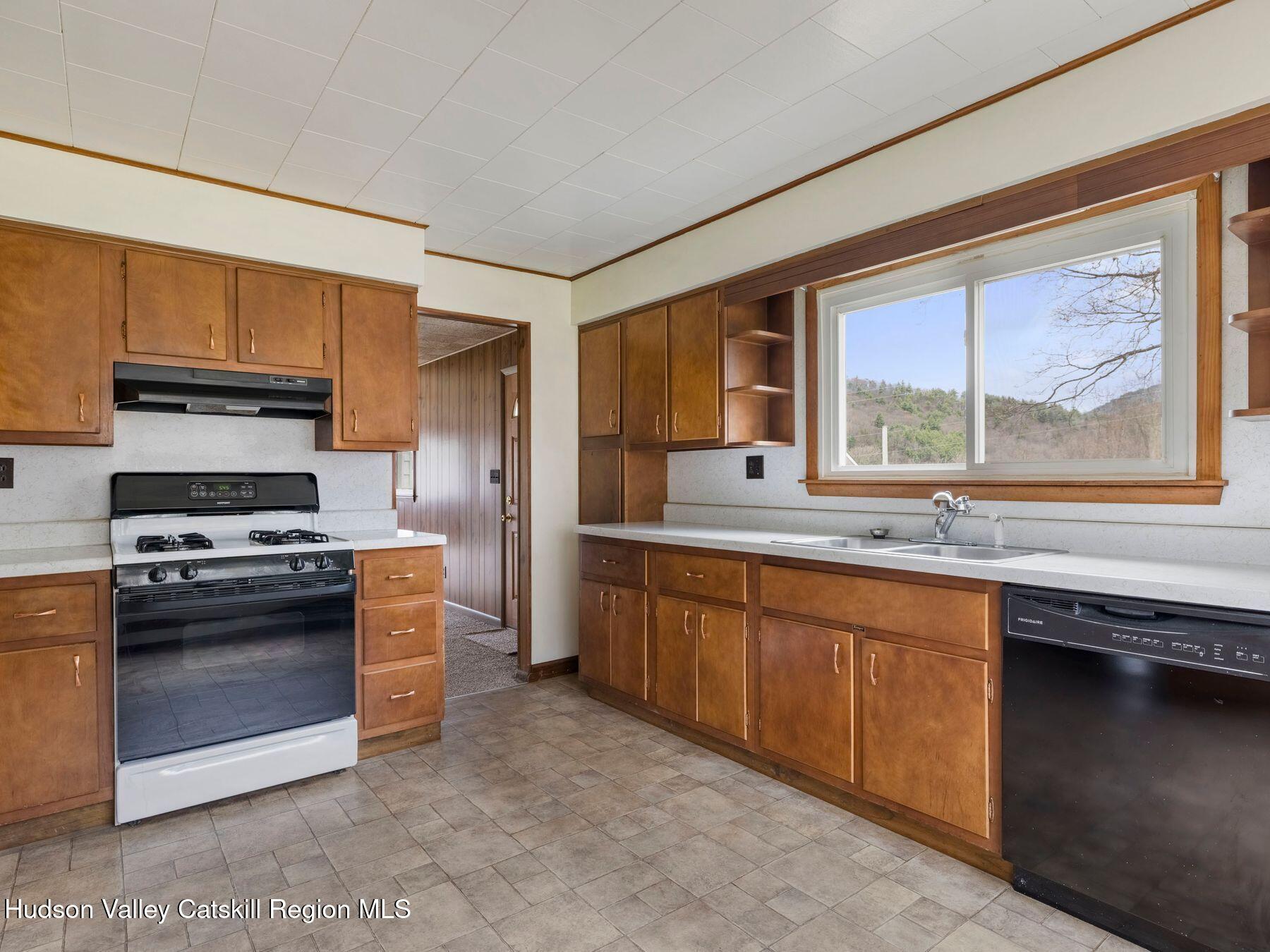 169 Mattice Road Prattsville, NY 12468 - Photo 26 of 52 a kitchen with stainless steel appliances granite countertop a stove a sink and a refrigerator