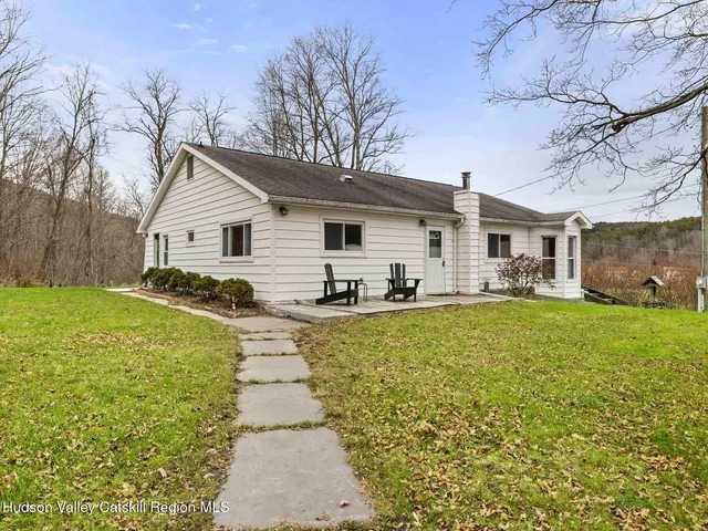 a view of a yard with large trees