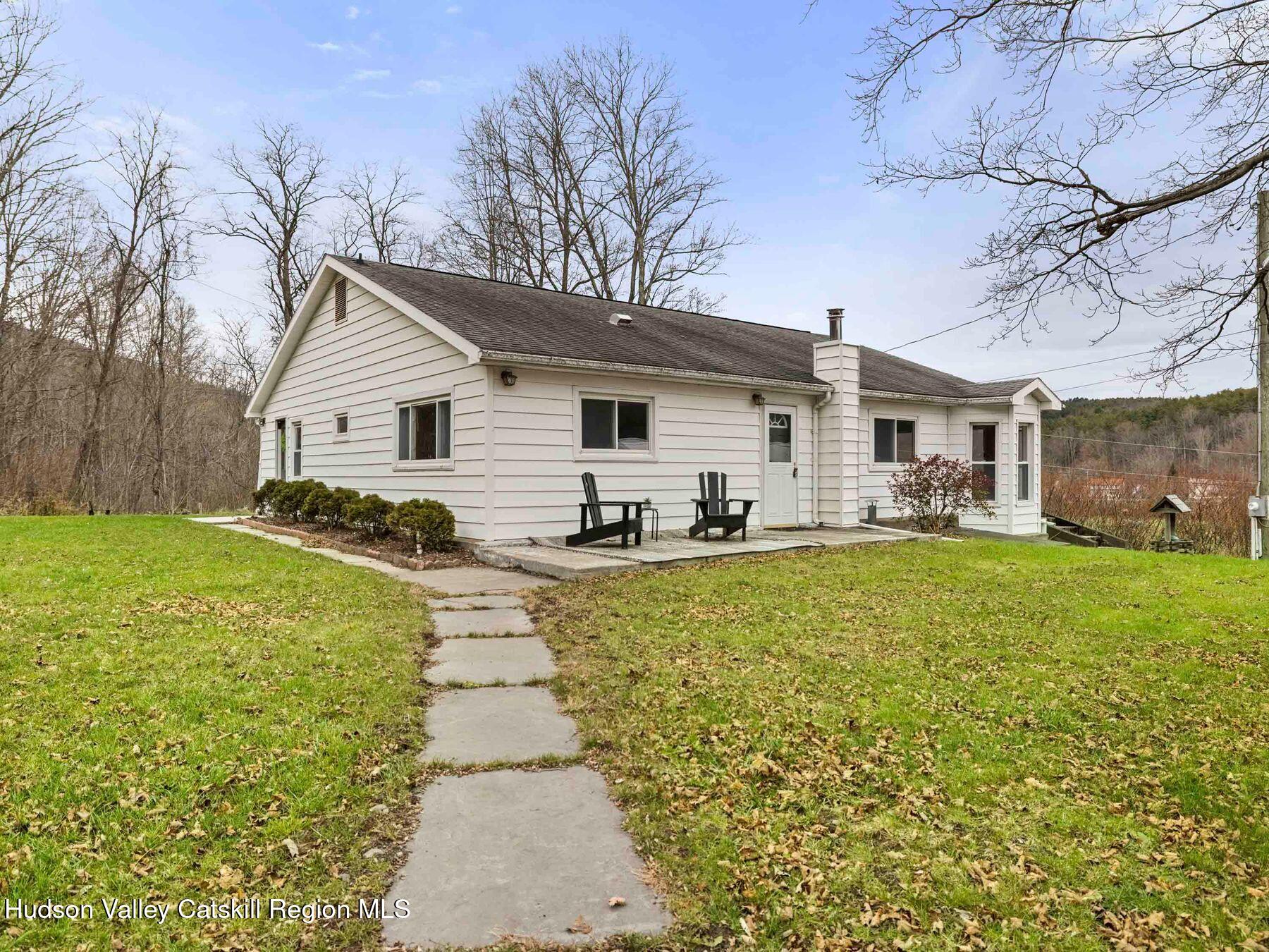 169 Mattice Road Prattsville, NY 12468 - Photo 3 of 52 a view of a house with pool and chairs with wooden fence