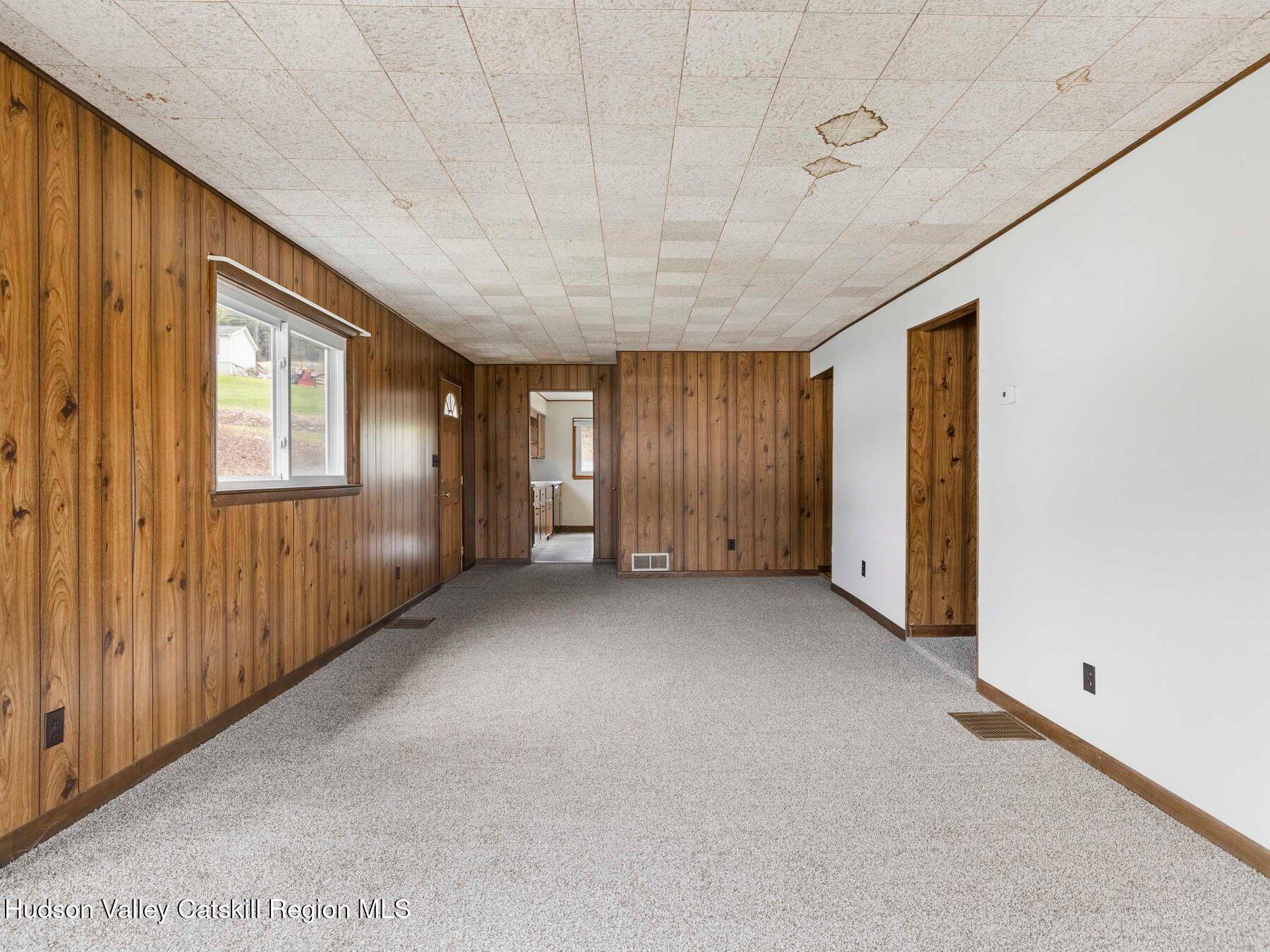 169 Mattice Road Prattsville, NY 12468 - Photo 34 of 52 a view of an empty room with windows
