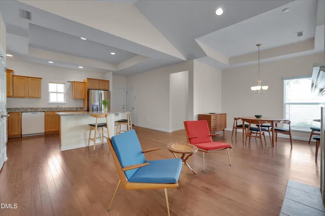 a living room with furniture and kitchen view