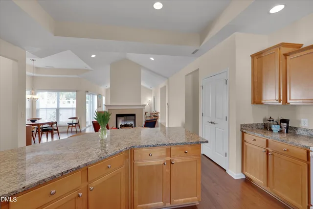 a kitchen with granite countertop a sink stainless steel appliances and cabinets