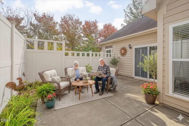 a view of a patio with table and chairs and potted plants
