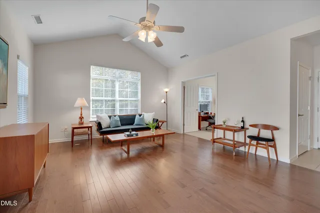 a living room with furniture wooden floor and a window
