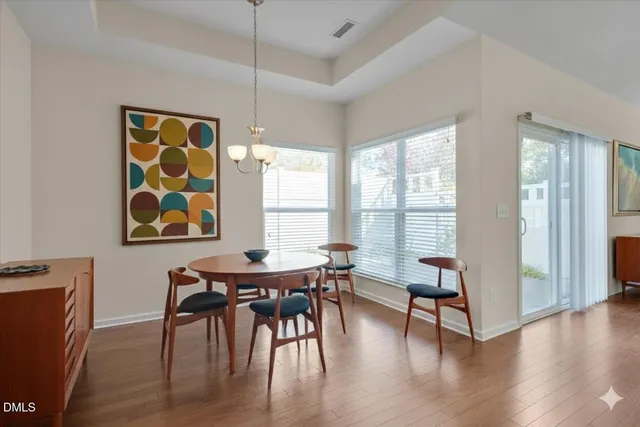 a view of a dining room with furniture and wooden floor