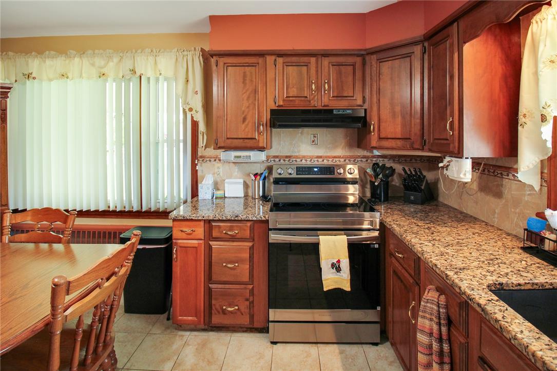 1256 Ridge Avenue Whitehall, PA 18052 - Photo 19 of 43 A well-equipped culinary space boasts rich wooden cabinetry and polished granite countertops.