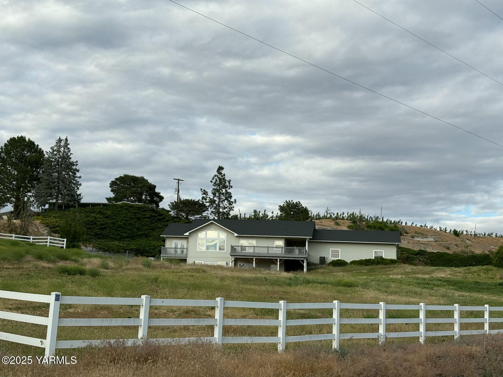 359 Riggins Road Wapato, WA 98951 - Photo 1 of 16 a view of a house with a big yard and plants